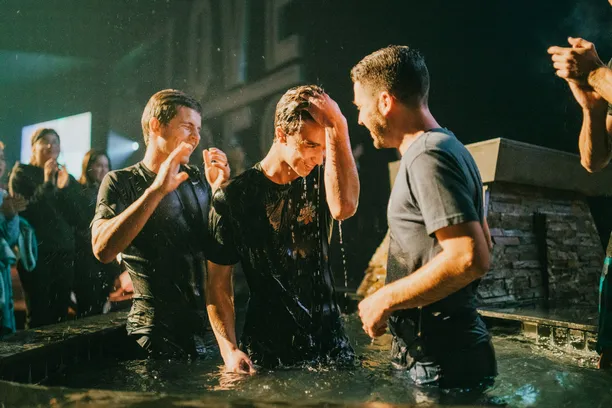 man getting baptized at church