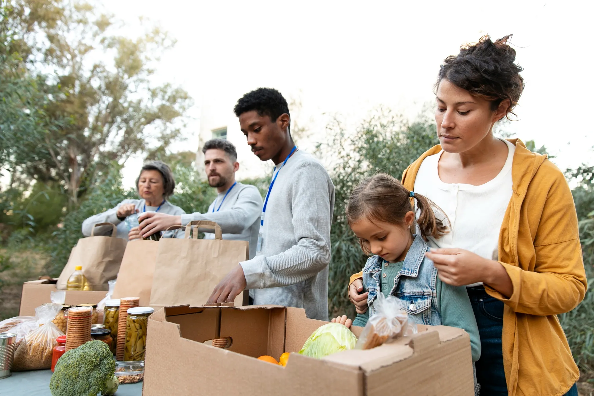 group of people and child helping to pass out food supplies