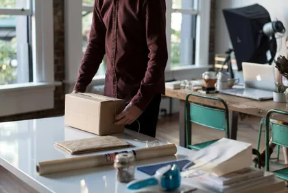 upper body of a man getting a package ready