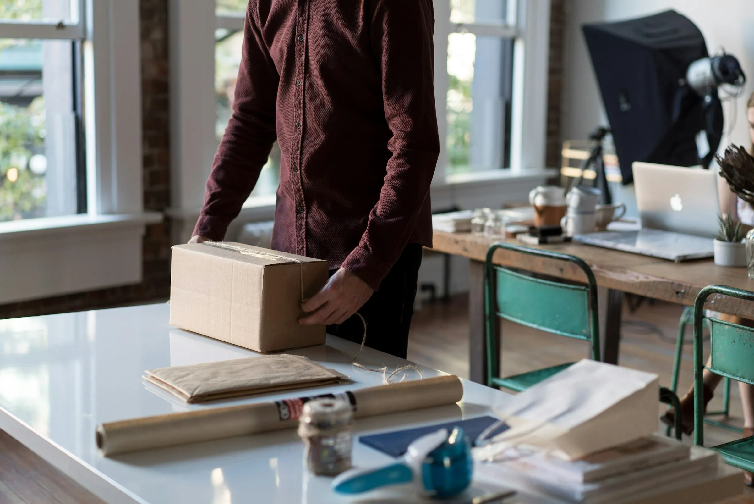 upper body of a man preparing to ship a package